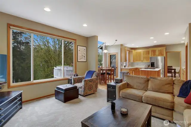 Another view of family room, kitchen and door out to expansive deck.