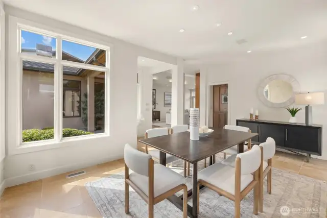 An oversized dining room, designed for both intimate gatherings and grand affairs, boasts sleek architectural details, programmable lighting, and built-in speakers, offering a truly customizable ambiance.