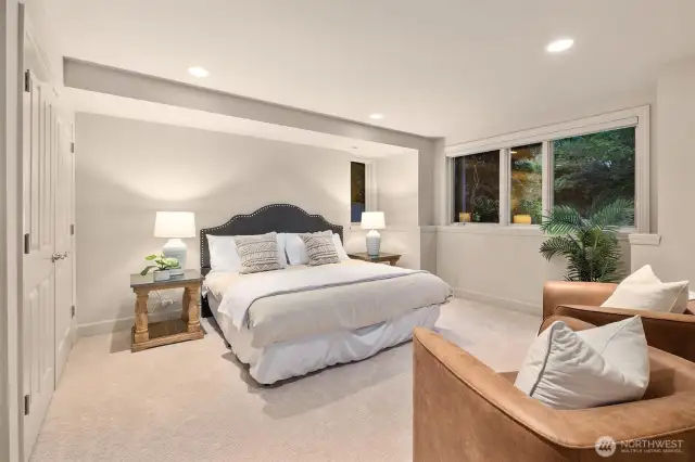An oversized lower-level en-suite bedroom featuring a large closet and private bathroom, offering a perfect blend of comfort and privacy.