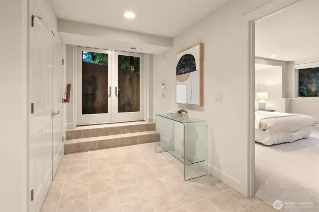 A separate entrance with French doors on the lower-level offers excellent potential for guest quarters, a nanny or caretaker suite, or multigenerational living.