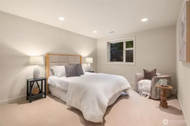 An expansive lower-level bedroom offers exceptional privacy, complete with a large closet and serene, tucked-away comfort.