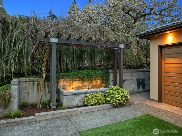 A welcoming water feature with programmable lighting creates a soothing and relaxing ambiance as you enter this thoughtfully designed home.