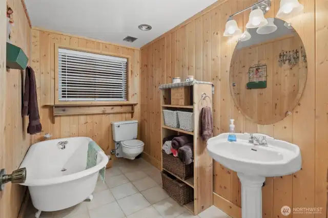 Powder room with claw foot soaking tub.