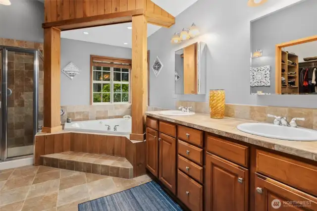5 piece primary bath with tile floors and countertops.