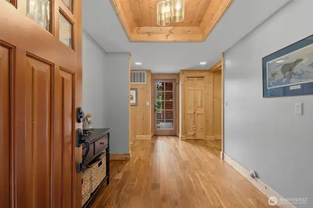 Entryway with coffered ceiling. Beautiful Arcacia hardwoods throughout hallway and kitchen.