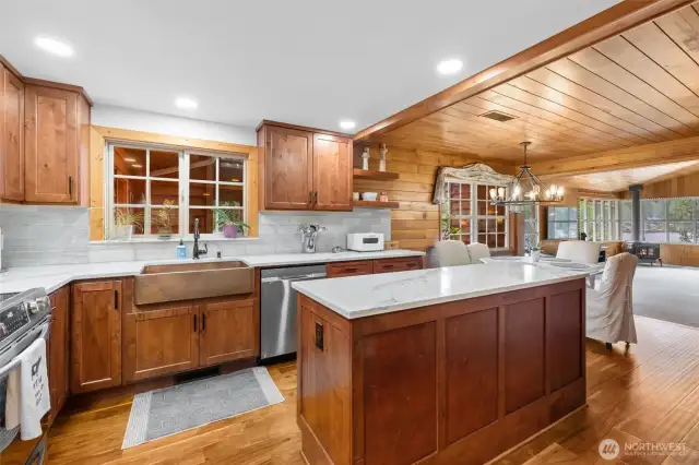 Recently updated kitchen with quartz countertops, copper sink, and stainless steel appliances.