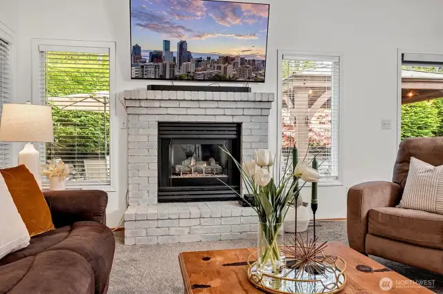 Generous living room features cozy gas fireplace.