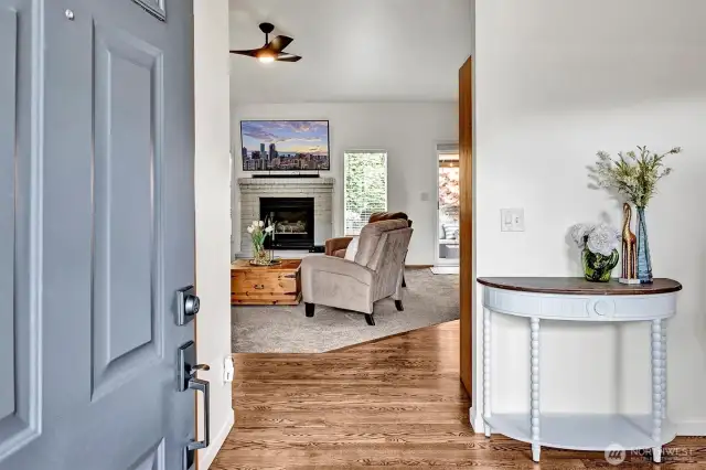 Welcoming entry open to rich hardwoods & vaulted ceilings