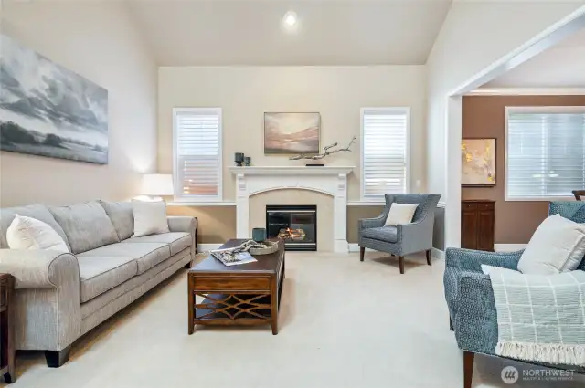 Formal living room with cozy gas fireplace, ideal for entertaining guests.