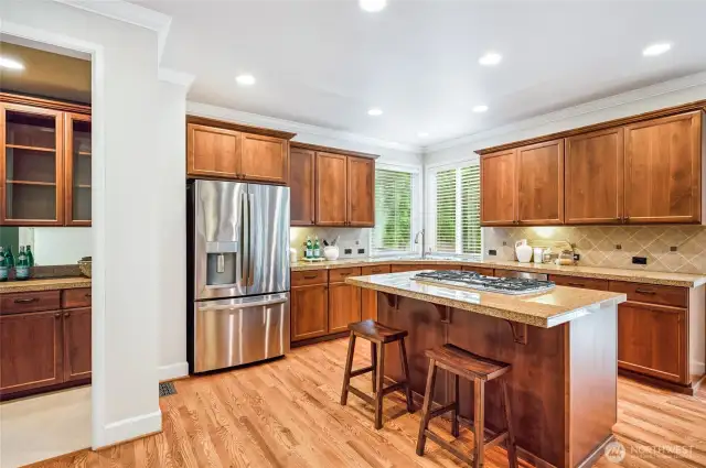 Kitchen island with gas stove is perfect for casual meals or prep work.