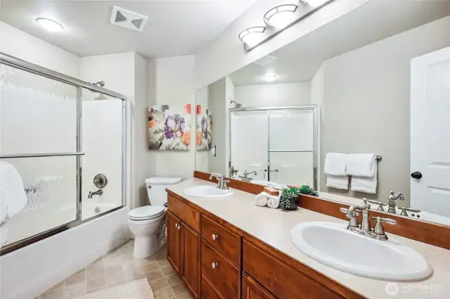 Elegant full bathroom featuring dual vanities.
