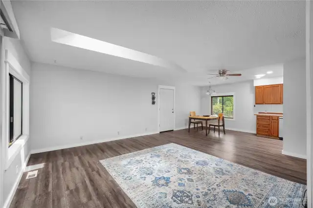 Great room with skylight looking towards dining room.  Sliding back door to the left.
