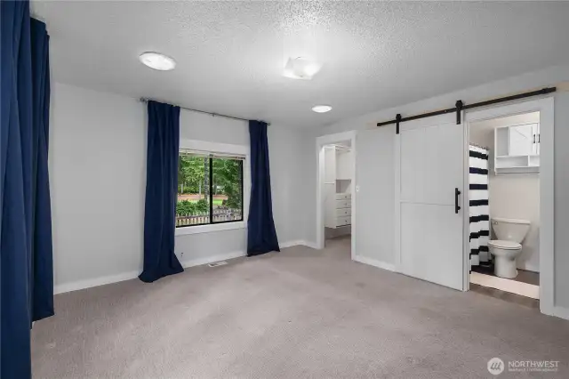 Barn door open to the full bath