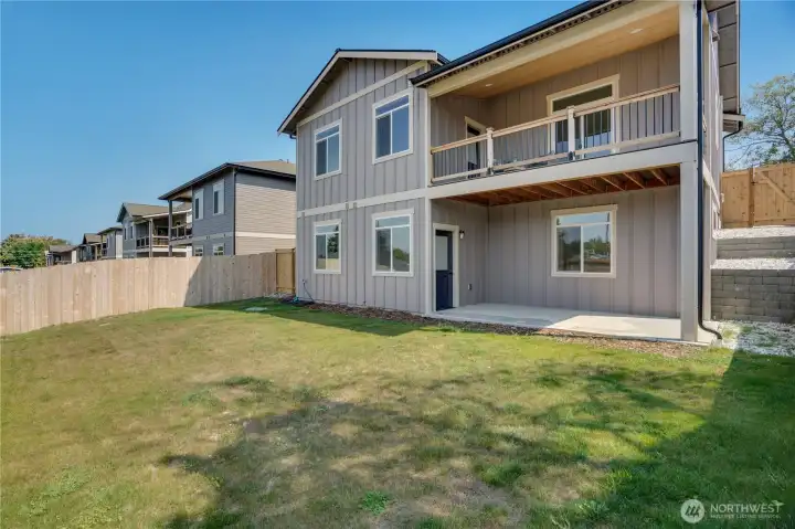 This large yard is fenced for your privacy, toys or pets.