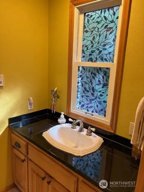 Pretty vanity with attractive sink and functional countertop for your bathroom essentials.