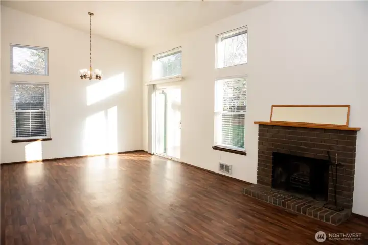Vacant gorgeous living room with vaulted ceilings and large windows!