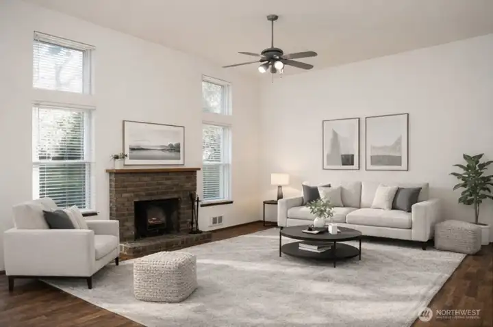 Virtually staged gorgeous living room with vaulted ceilings, large windows & ceiling fan!
