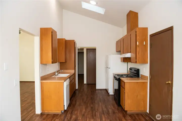 Vacant kitchen with professionally freshly varnished cabinets with ample storage and lots of potential.