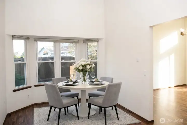 Virtually staged dining room with beautiful bay window!
