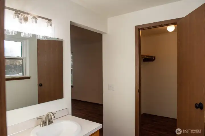 Primary bath with updated lighting, countertops and faucets & walk in closet!