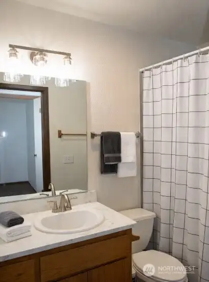 Second bath with updated lighting, countertops and faucets! Bath includes tub & shower.