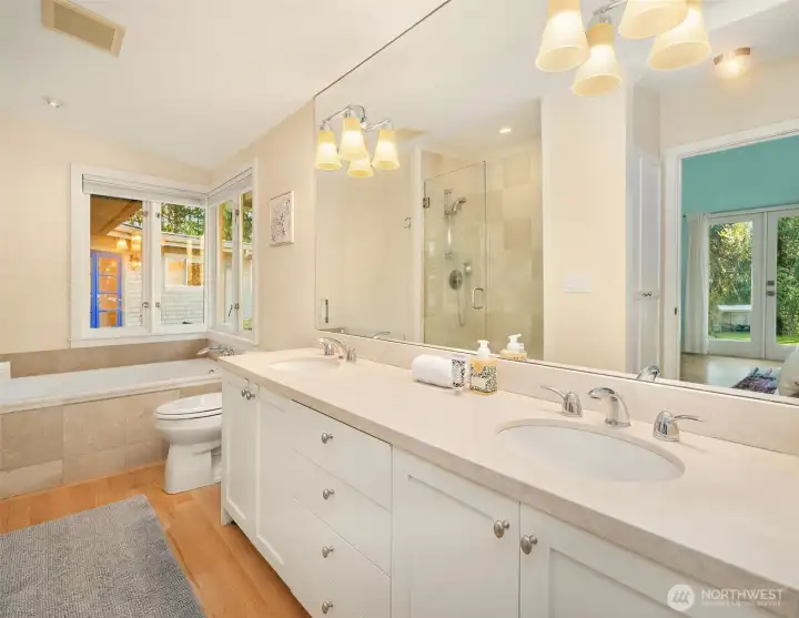 The primary bath with double sinks, stone counter top, tiled shower and soaking tub. A luxurious bathing experience or a quick shower and out the door; your choice every day!