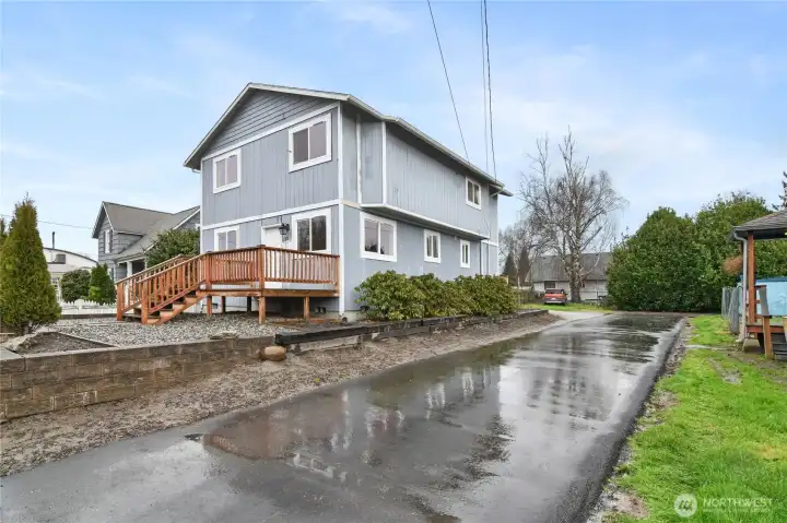 Driveway to rear with two designated parking spots