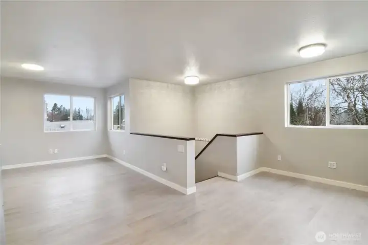 Upstairs open living space with natural light throughout