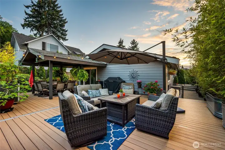 The uncovered portion of the large back deck has potted plants for privacy hedges and other low maintenance and mature plants in the garden The uncovered portion of the large back deck has potted plants for privacy hedges and other low maintenance and mature plants in the garden