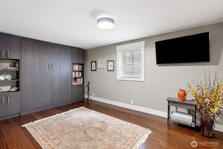 Bedroom 2 downstairs functions as an optional workout room and guest room with this built in Murphy bed which stays with the home. It has built in lighting and, bookshelves and pull out trays for night tables. The mattress rarely used will stay as well. Not shown is a large walk in closet as well as a utility closet for the water heater Bedroom 2 downstairs functions as an optional workout room and guest room with this built in Murphy bed which stays with the home. It has built in lighting and, bookshelves and pull out trays for night tables. The mattress rarely used will stay as well. Not shown is a large walk in closet as well as a utility closet for the water heater