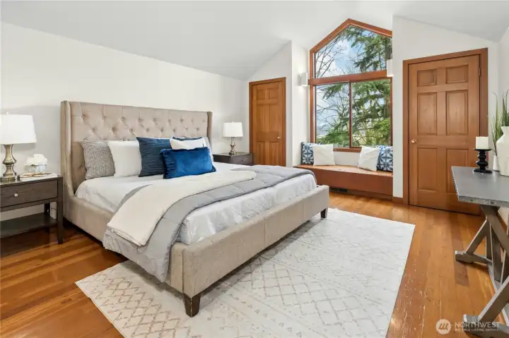 Primary bedroom with vaulted ceilings.
