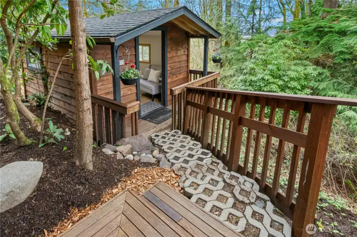 Detached outbuilding is so cute and fits right in with the main house.