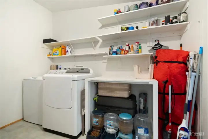 This oversized utility room with enough shelving to use a pantry