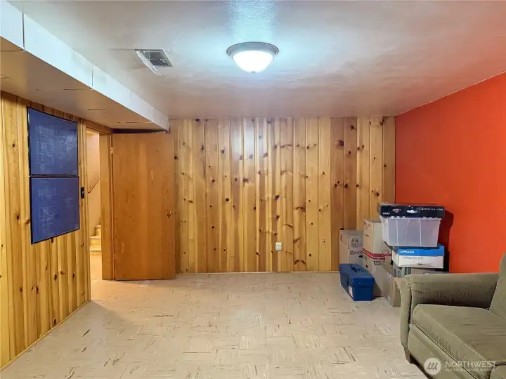 Additional basement living space with rustic charm