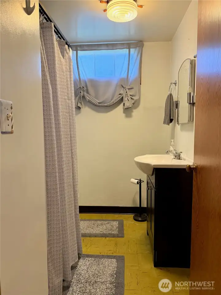 Basement hallway with access to additional rooms