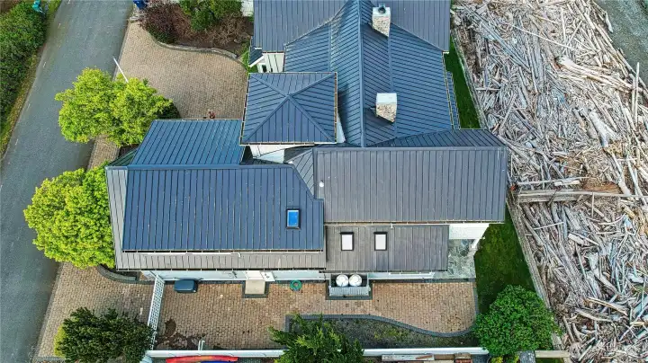 All metal roof handsome pavers, fenced yard to street, side area parking perfect for a trailerable boat, generator Propane tanks and even an out door shower.