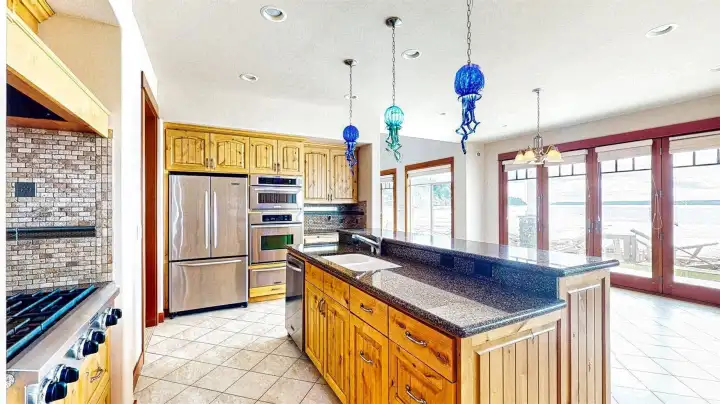 Gas KitchenAid cooktop with generous BTU capacity and extra burners.
