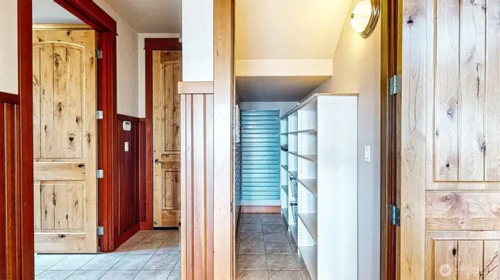 The back hall way from the kitchen has the walkin panty on the right  and the ........