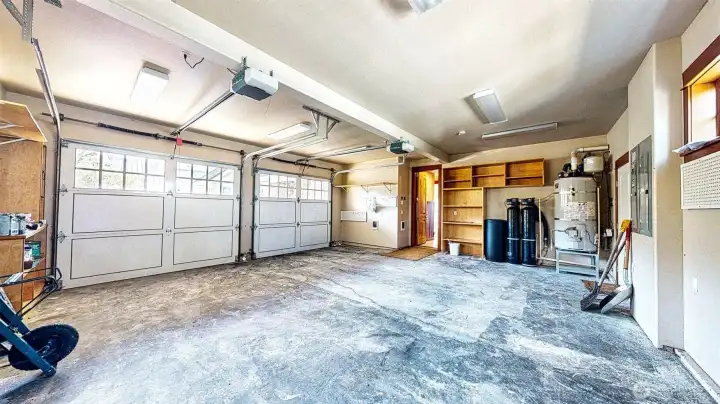 The spacious garage has two generous width doors and plenty of room for a workbench and tools. there is a "person" door that takes you to the side yard gated parking area.