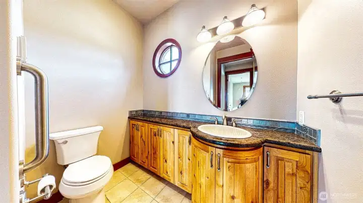 Past the stairs, entry door and closets is the powder room with a fantastic rounded counter.
