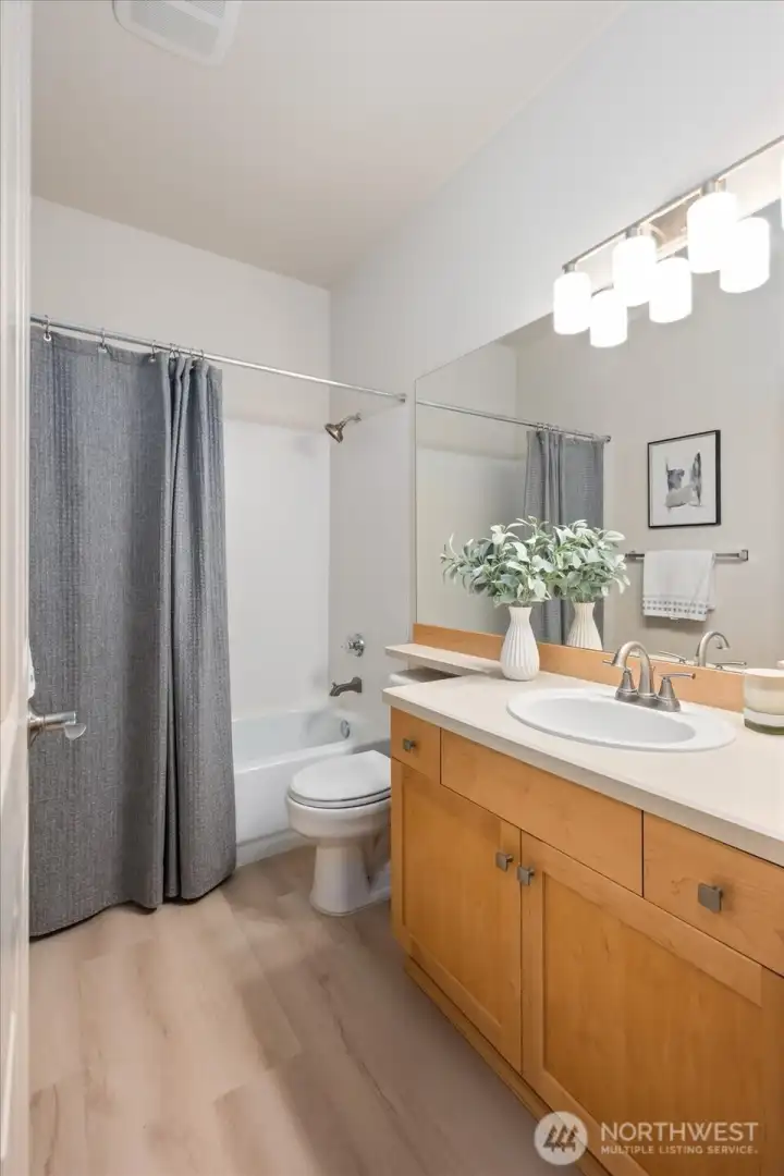 This second bathroom with new floors, new light fixtures and tub/shower is the guest/common bathroom.