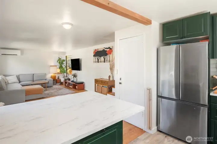 Eating bar that opens to the sun-filled living room with gorgeous hardwood oak floors and great light from the tall, south-facing windows