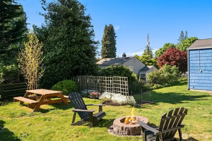 Huge, fully fenced, peaceful backyard with fire pit, picnic table and garden beds