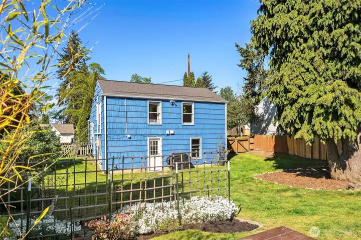 Huge, fully fenced, peaceful backyard with fire pit, picnic table and garden beds