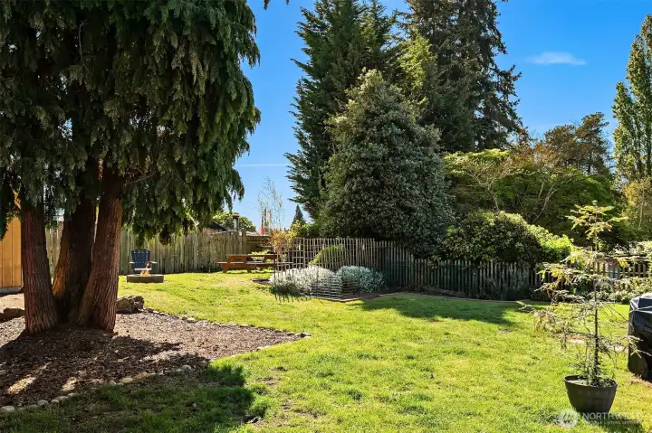 Huge, fully fenced, peaceful backyard with fire pit, picnic table and garden beds