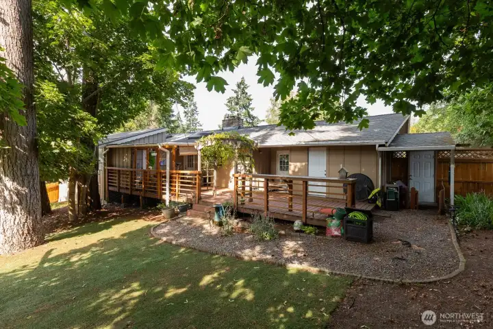 Backyard with beautiful covered deck area.