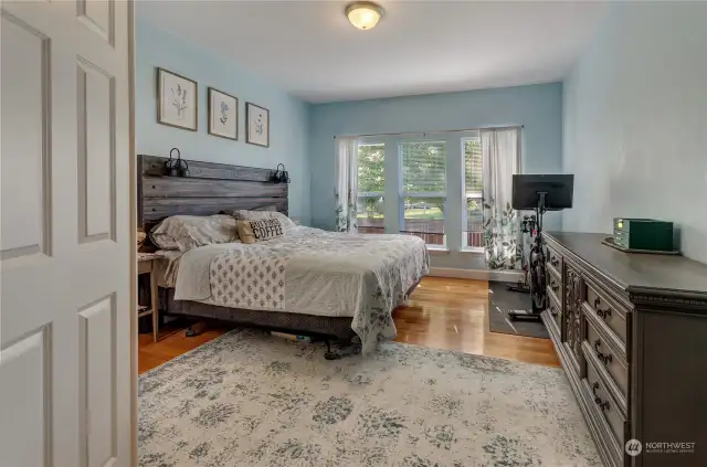 Large primary bedroom located on the main level. The hardwood floors continue into this room as well.