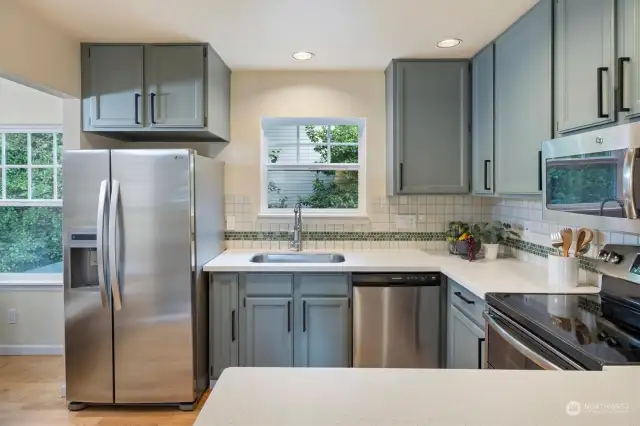 The kitchen boasts of stainless-steel appliances, solid surface countertops with a complementing backsplash.