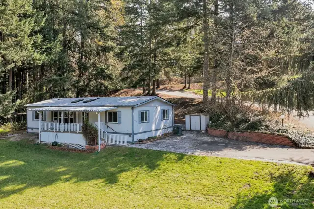 Enjoy the country setting, tucked away from traffic and noise. Wide steps leading to the covered deck off the formal entry into the home. NEW ROOF 3/2025. Small yard for fido or play area/big toy. Two sheds at the back of the home for yard tools etc.