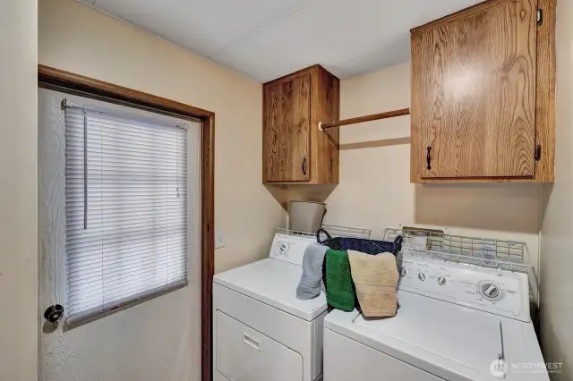 Utility room access door to the back yard area. Storage cabinet above the washer and dryer for all your laundry supplies. Corner closet for linens or cleaning supplies as there is an access door the the full bath here also.